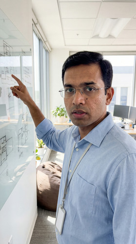 dv04 sanjay whiteboard pointing up.jpg