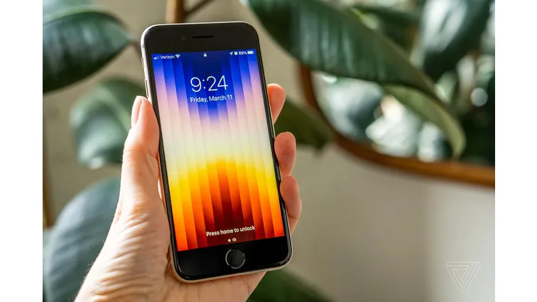 A photo of a person holding an iPhone SE (2022).