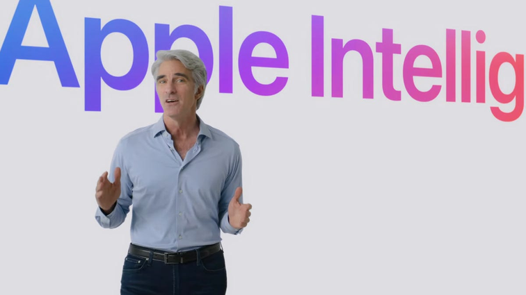 None A man in a blue shirt and silver hair talks in front of a large screen that reads