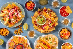 145158999-mexican-food-variety-shot-from-above-nachos-guacamole-tequila-tacos-and-other-dishes-a-fla.jpg