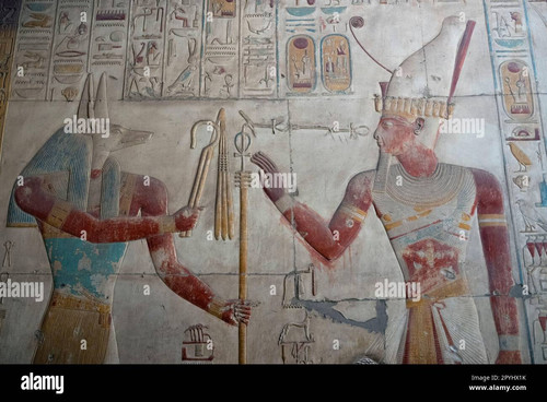 bas relief of the god anubis and ramses ii on the walls of the temple of seti i in abydos 2PYHX1K.jpg