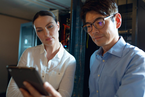 diverse male female engineers using digital tablet computer server room database server management m.jpg