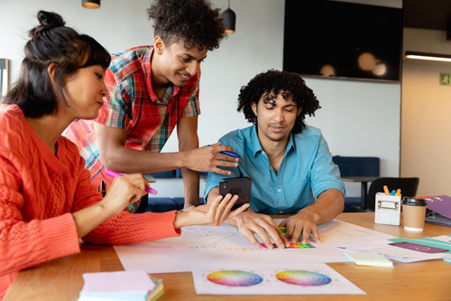 creative multiracial design professionals discussing charts smart phone office 13339 334359.jpg