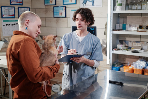 woman with dog visiting vet clinic 249974 11218.jpg