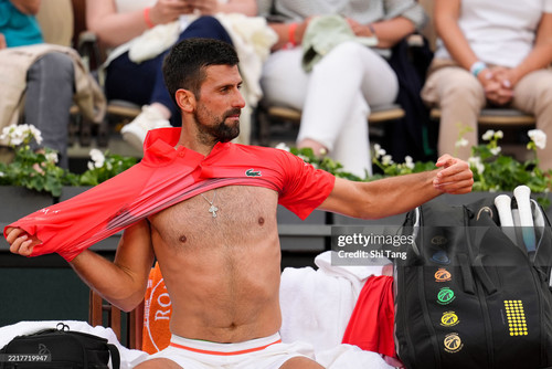 PARIS, FRANCE - MAY 29: Novak Djokovic of Serbia changes shirts during a change over in the Men's Si.jpg