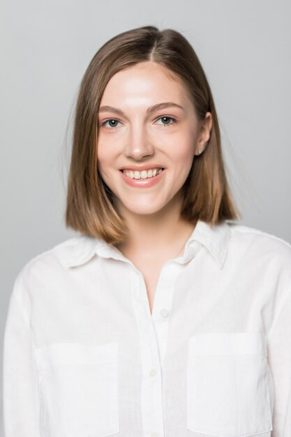 smiling young business woman against white wall 231208 10791.jpg