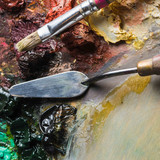 brush taking paint near palette knife