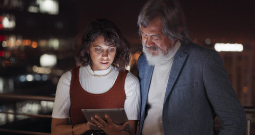 business team tablet night city building rooftop talking global networking digital marketing social .jpg