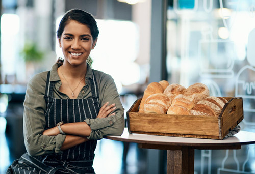 indian woman portrait confidence cafe bread baking startup development with apron entrepreneur face .jpg