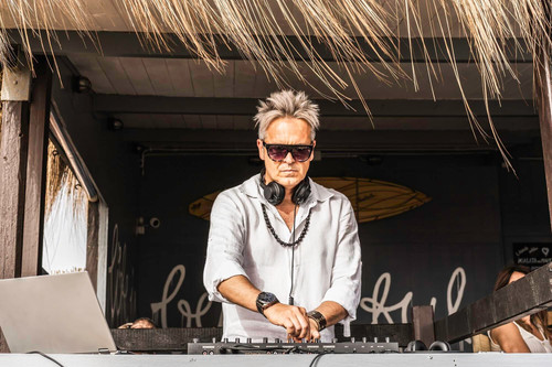 disc jockey playing music tourist people club party outdoors beach dj wearing headphones music live .jpg