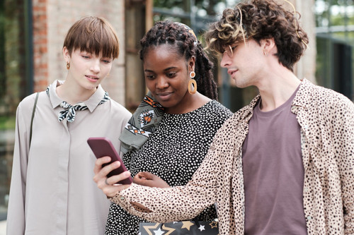 group friends using mobile phone together while walking city 249974 10115.jpg