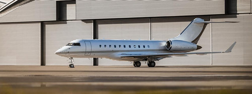 private jet on parked in front of a warehouse.jpg