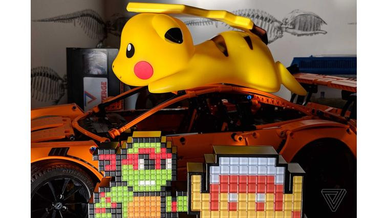 None A plastic yellow dog on top of a toy car amid other toys.