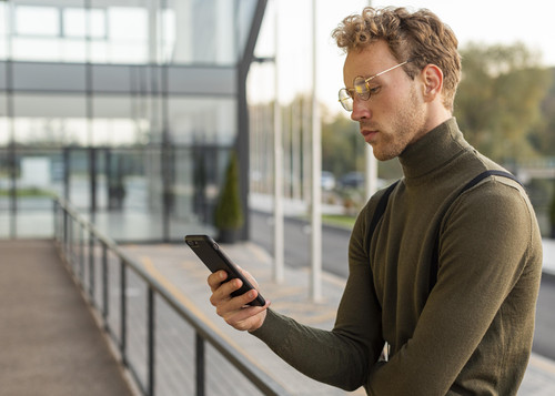 beautiful male model browsing through his phone.jpg