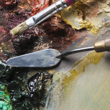 brush taking paint near palette knife