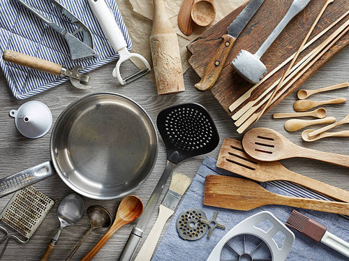 various kitchen utensils on wooden table, top view.jpg