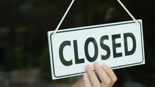 the hand turns the sign with the inscription open to the closed position the end of the.jpg
