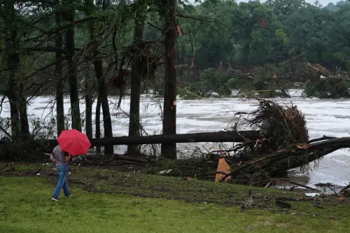 A man surveys damage left by a raging Guadalupe River, Friday, July 4, 2025, in Kerrville, Texas.