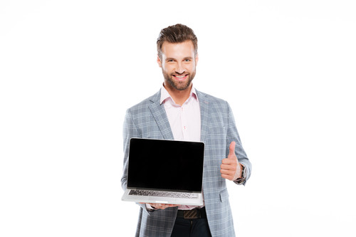 cheerful young man holding laptop showing thumbs up.1