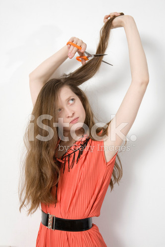 8861579 portrait young angry woman cutting her hair.jpg