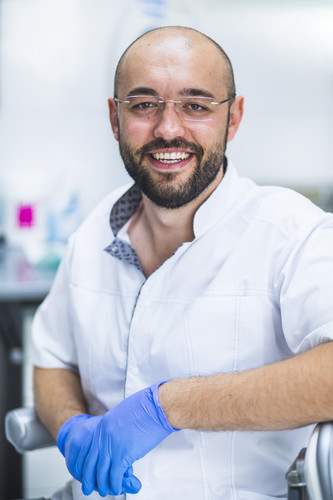 portrait happy dentist with eyeglasses.jpg