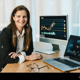 cheerful woman trading on binary option in office 2GY4T61