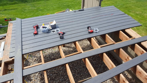 New deck constructed from a Composite Decking Material. PVC Gray plastic with a wood grain. Supports.jpg