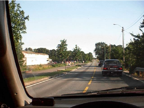 A driver looks through the windows of the car he is following to see what is the.png