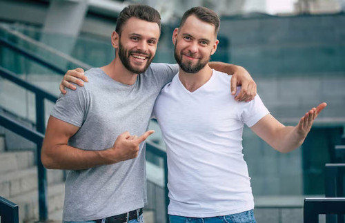 two happy excited handsome bearded best friends casual clothes are handshaking hugging while standin.jpg