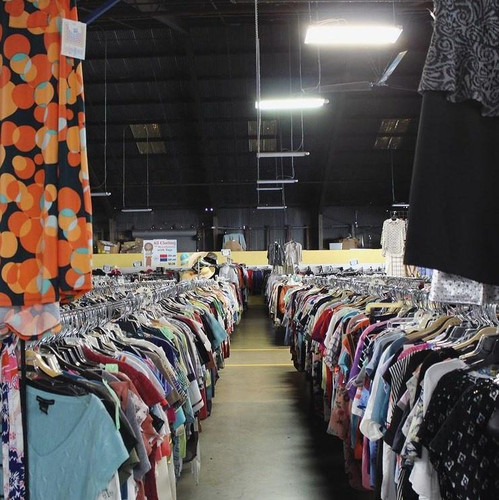 Aisle of donated clothes for sale at a Vinnies thrift store.jpg