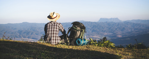 tourist from mountain top sun rays man wear big backpack against sun light (2).jpg