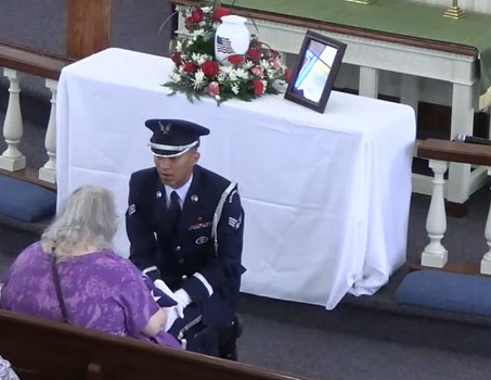 HB Mem Serv Being handed flag.jpg