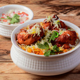 Chicken Tikka Biryani made of Basmati rice cooked with masala spices, served with yogurt, selective 