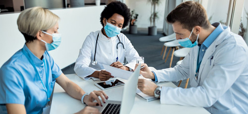 african american doctor analyzing medical reports with her colleagues clinic.jpg