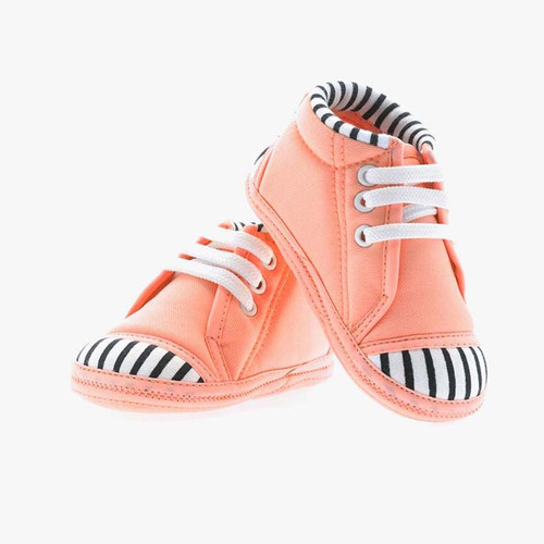 Smiling beautiful young woman in pink mini dress posing and looking at camera. Three quarter length .jpg