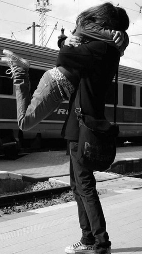 cute couple hugging by train black and white jwj4hefpb3woxovk.jpg