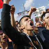 Kurds of the ethnic minority of Yazidis shout slogans against IS militants durin
