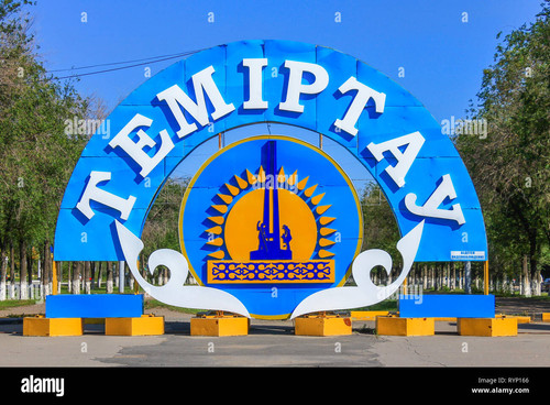 emblem and flag of city temirtau on the end of the main promenade outgoing street of temirtau kargan