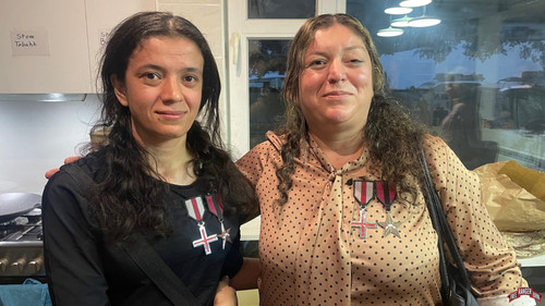Sousan left and her mother reunited wearing the medals FBR awarded them for bravery and suffering.jpg
