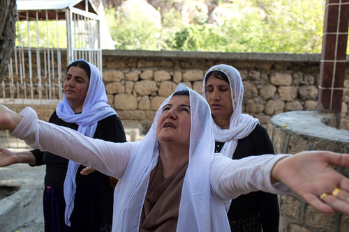 A Yazidi woman prays on the sacred grounds of Lalish..jpg