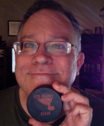 DE with KC Blues puck.jpg