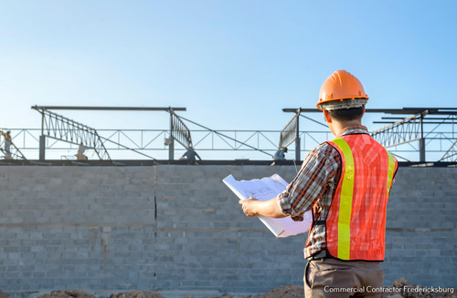 A construction worker plan checking Construction site area During working hours.jpg