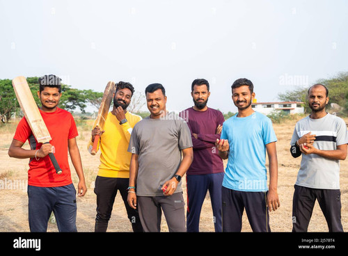 focus on man with yellow t shirt team of cricket players with bat and ball coming and standing by lo.jpg