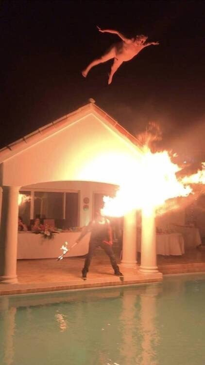 dive off of peak of roof into pool, illuminated by firebreather.jpg