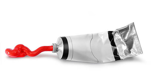Red paint tin tube squeezed on white background isolated.jpg