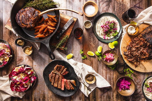 flatlay iron skillet with meat and other food.jpg