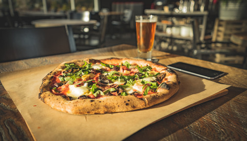 dinner for one of wood fired pizza paired with cold beer.jpg