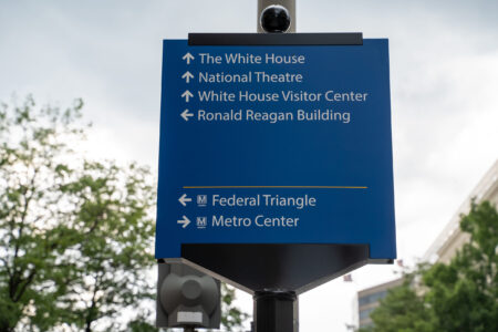Washington, DC - August 7, 2019: Sign gives directions to famous DC landmarks for tourists (White Ho.jpg