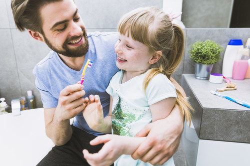 Dental clinic in Satwa father daughter brush togethet.jpg
