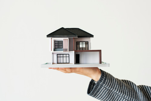 Hand presenting model house for home loan campaign.jpg